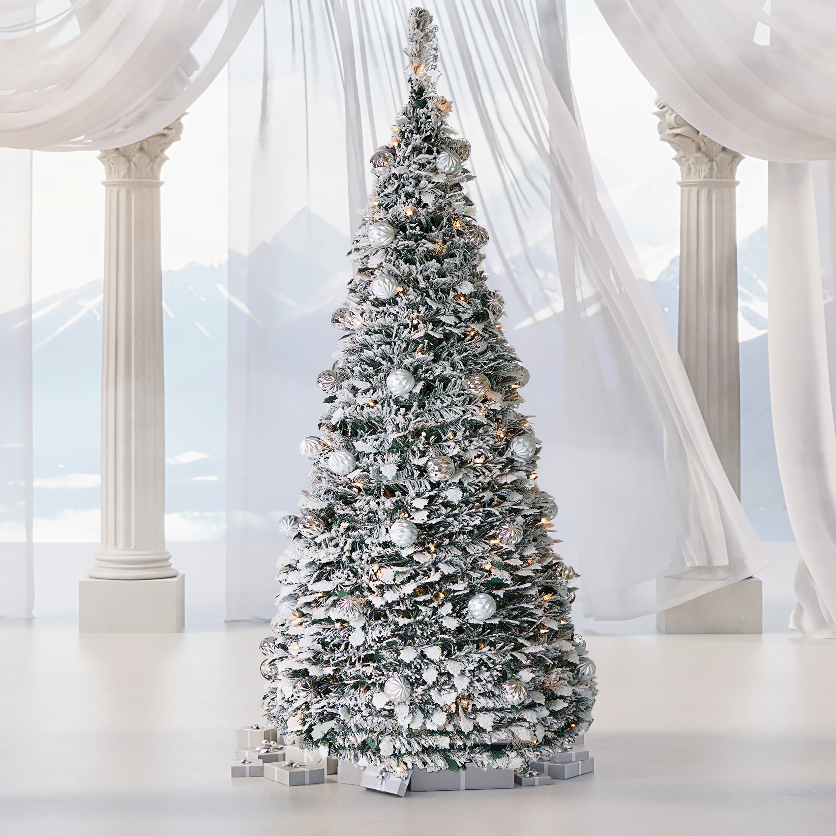 Sapin de Noël artificiel pliable, pré-éclairé, enneigé, décoré de boules argentées, avec paysage de montagne et colonne en arrière-plan, Maison Eira